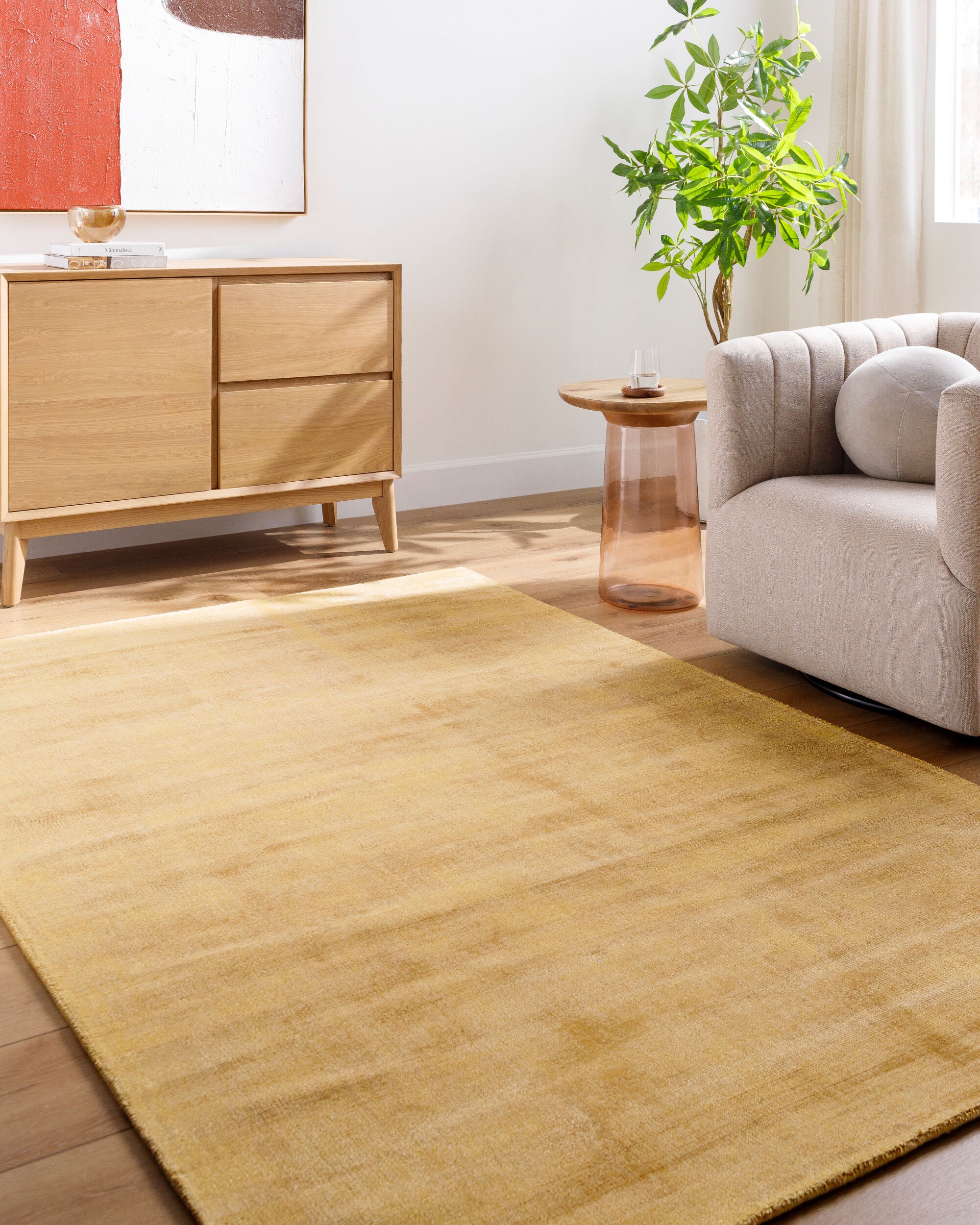 Golden beige textured area rug with subtle worn distressed pattern throughout