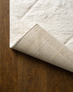 Cream quilted diamond pattern wool area rug with subtle texture