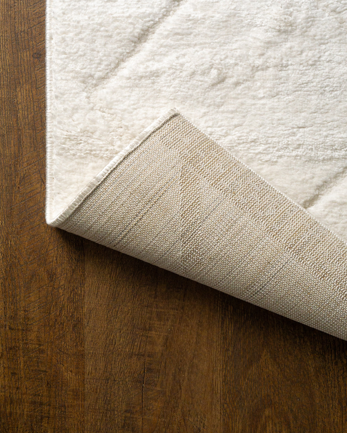 Cream quilted diamond pattern wool area rug with subtle texture