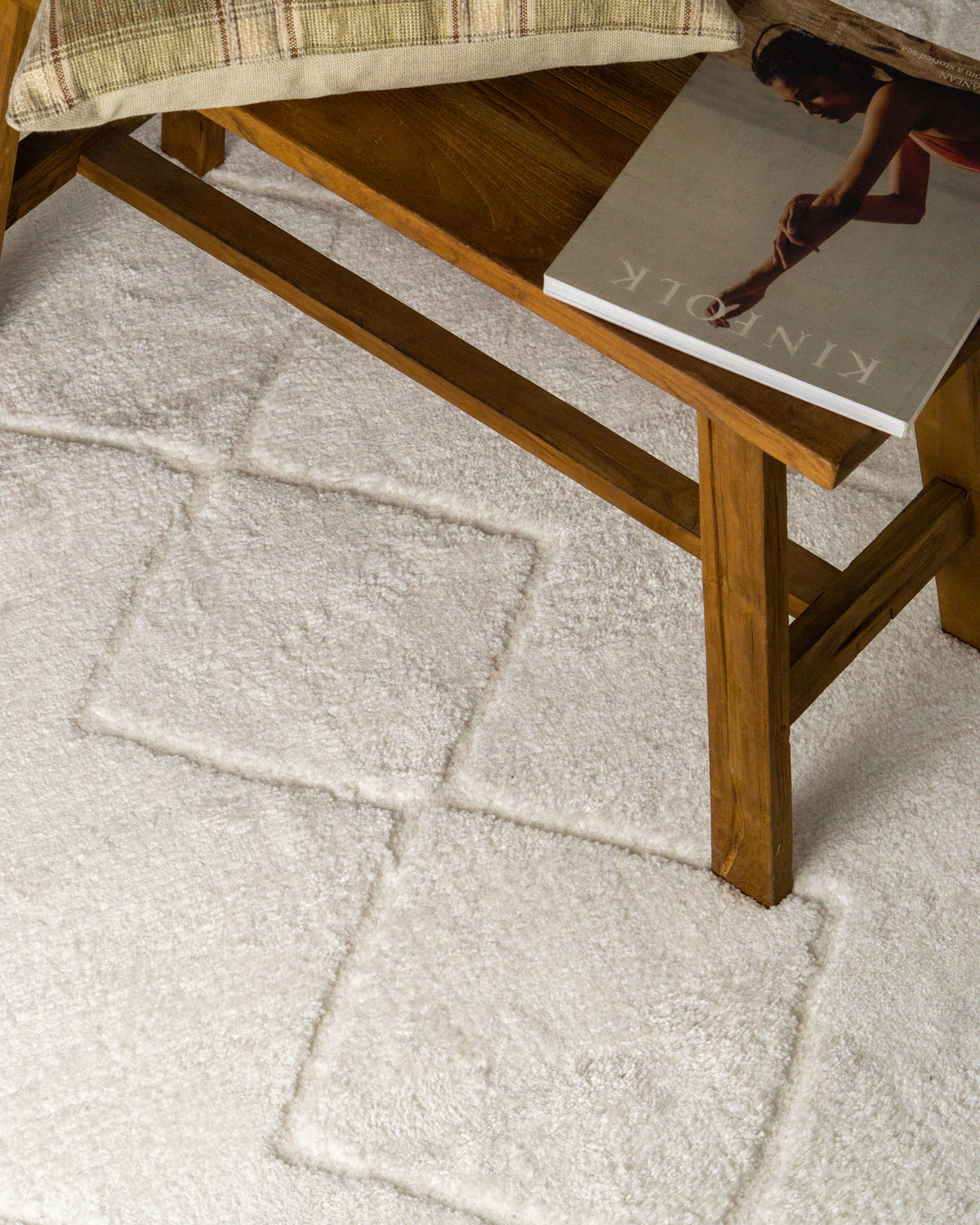 Cream quilted diamond pattern wool area rug with subtle texture