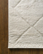 Cream quilted diamond pattern wool area rug with subtle texture