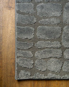 Grey crocodile textured area rug with geometric pattern in neutral tones