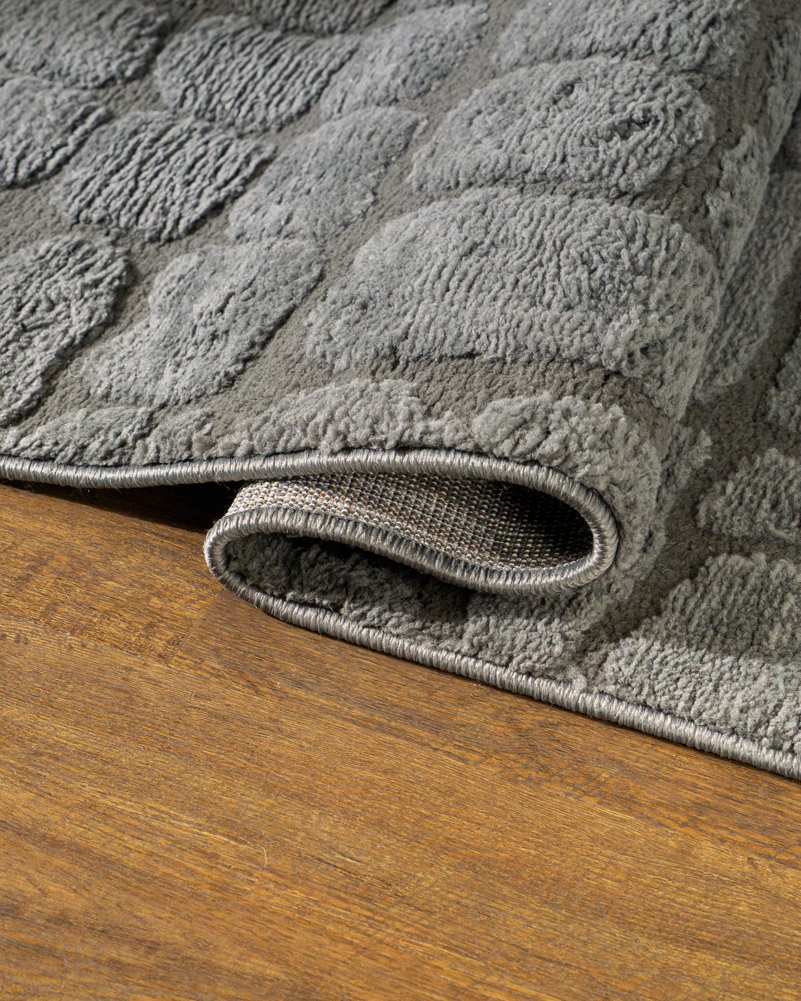 Grey crocodile textured area rug with geometric pattern in neutral tones