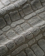 Grey crocodile textured area rug with geometric pattern in neutral tones