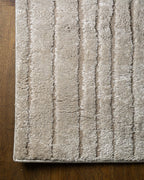 Beige geometric rug with concentric rectangles and vertical striped pattern