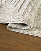 Beige geometric rug with concentric rectangles and vertical striped pattern