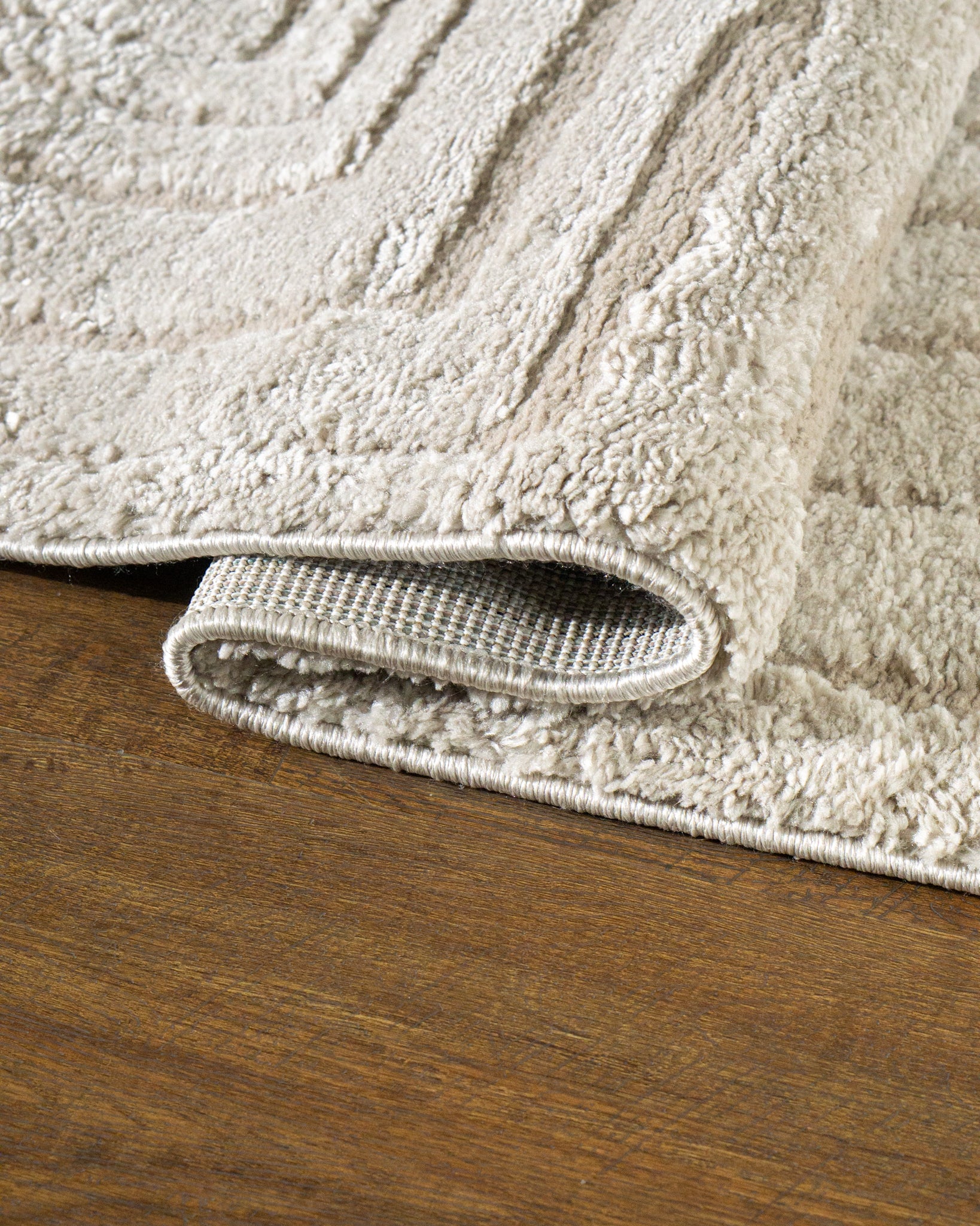 Beige geometric rug with concentric rectangles and vertical striped pattern