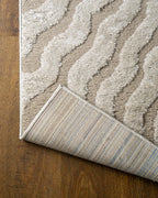 Beige and cream wavy geometric pattern rug with radiating sunburst design