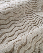 Beige and cream wavy geometric pattern rug with radiating sunburst design