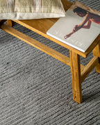 Grey textured area rug with horizontal woven pattern and neutral tone