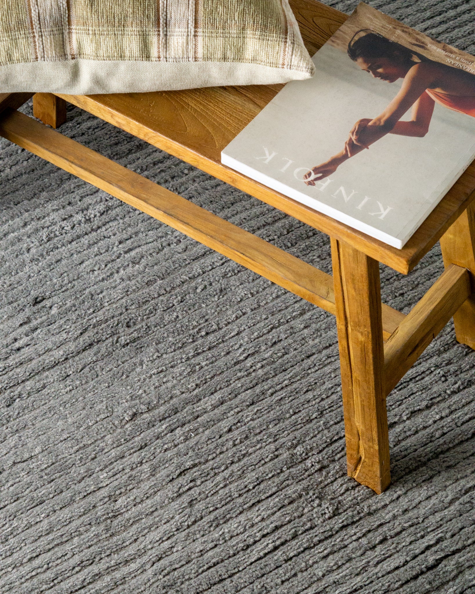 Grey textured area rug with horizontal woven pattern and neutral tone