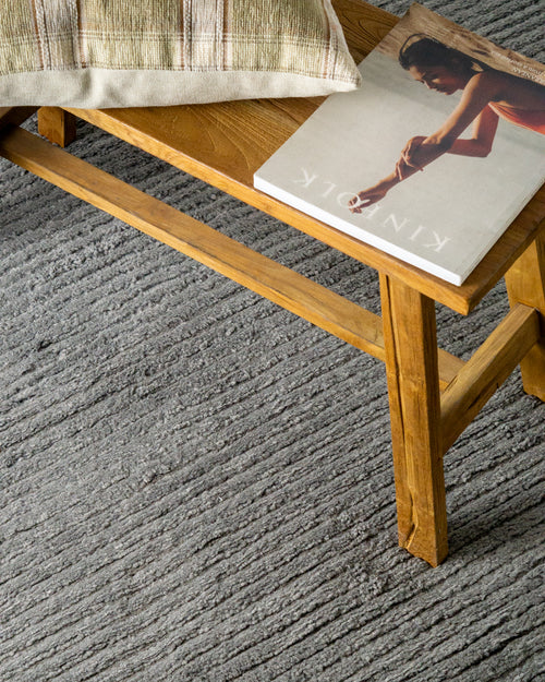 Grey textured area rug with horizontal woven pattern and neutral tone