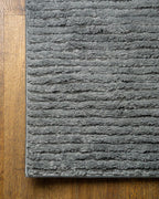 Grey textured area rug with horizontal woven pattern and neutral tone