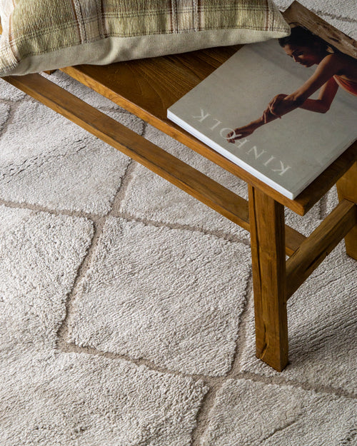 Beige geometric rug with diamond quilted pattern and subtle texture