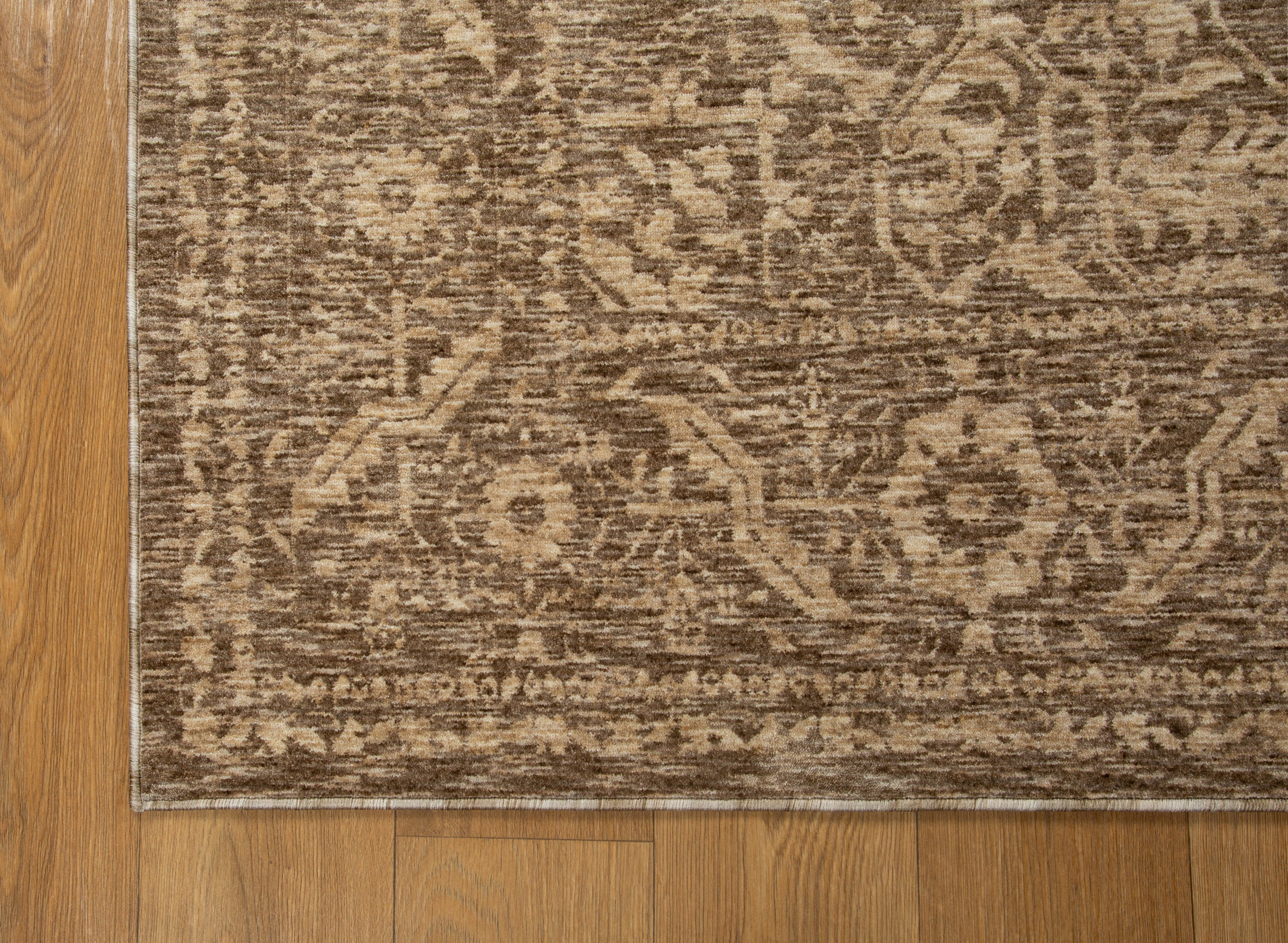 Taupe geometric damask patterned rug with textured woven appearance