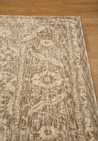 Taupe geometric damask patterned rug with textured woven appearance