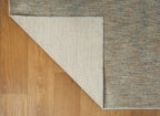 Neutral beige wool rug with subtle textured weave pattern throughout