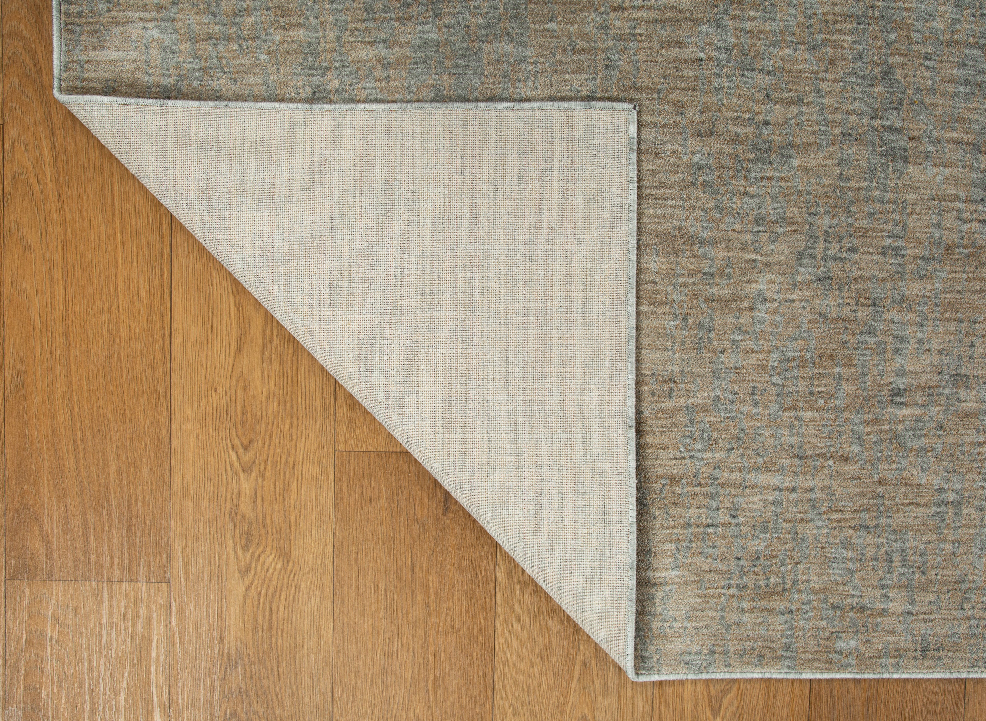 Neutral beige wool rug with subtle textured weave pattern throughout