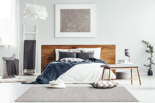 Neutral beige wool rug with subtle textured weave pattern throughout
