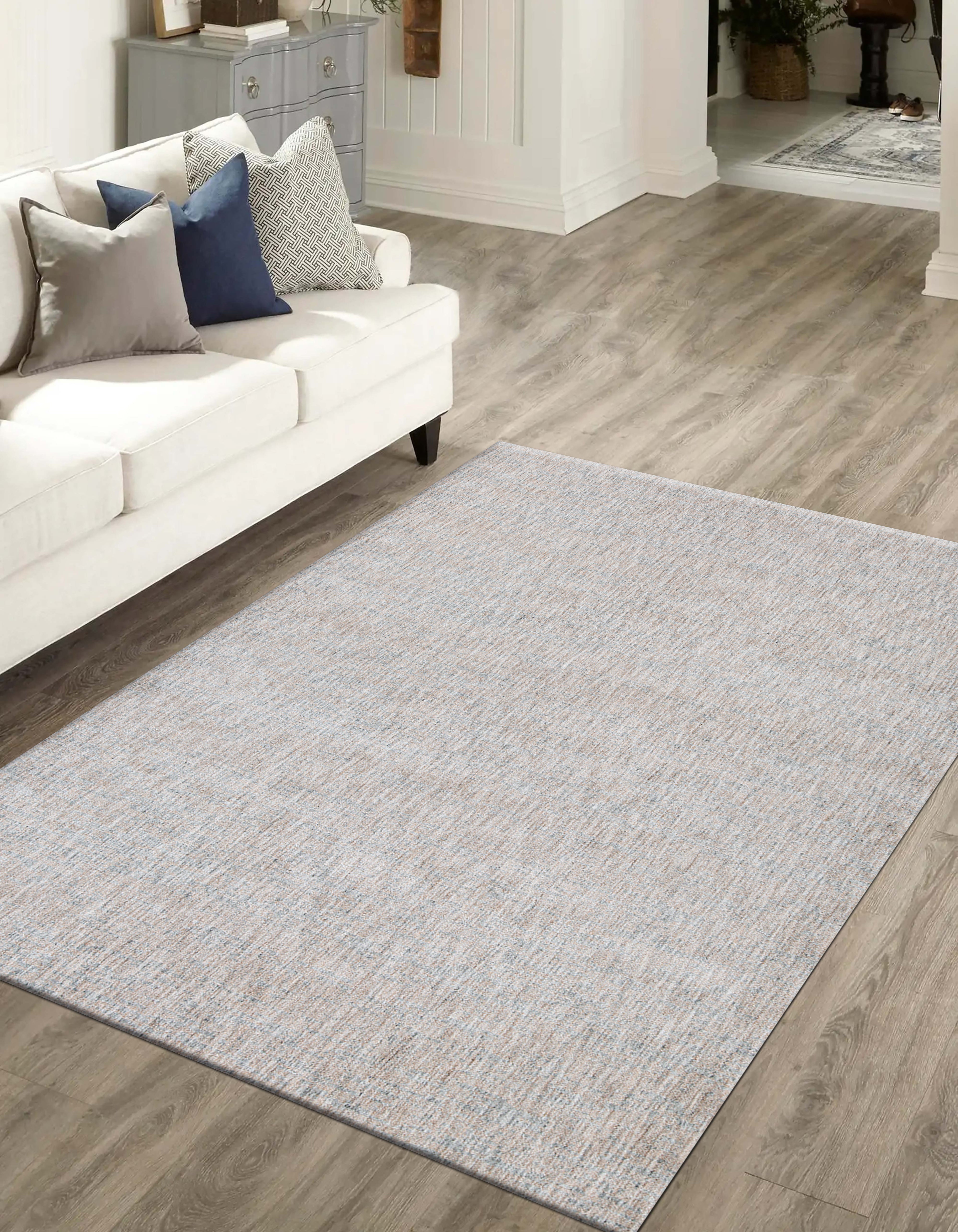 Neutral beige wool rug with subtle textured weave pattern throughout