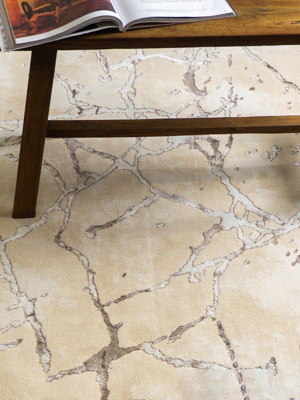 Beige crackle pattern rug with abstract veining and neutral earth tones