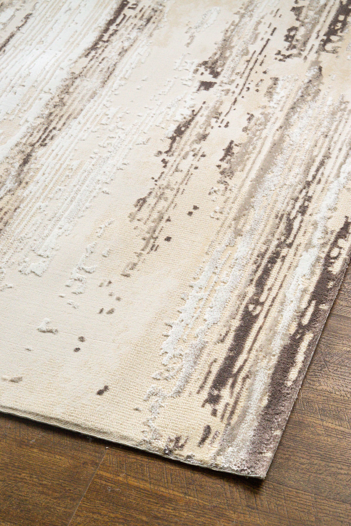 Distressed cream and brown striped area rug with weathered texture