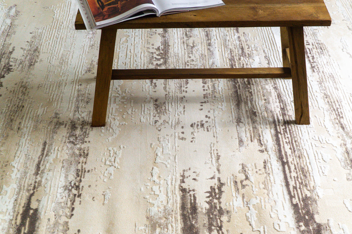 Distressed cream and brown striped area rug with weathered texture