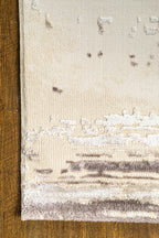 Distressed cream and brown striped area rug with weathered texture