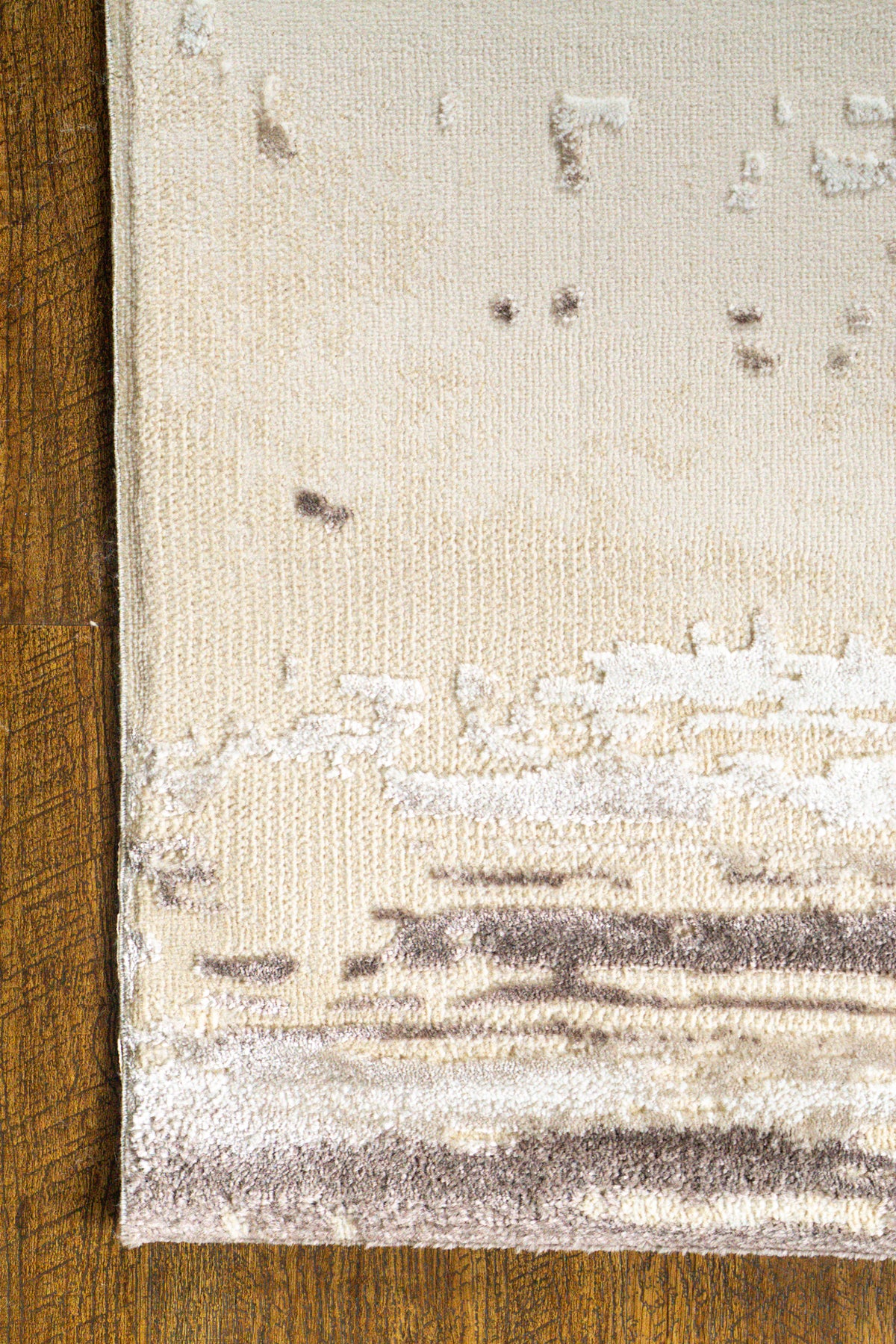 Distressed cream and brown striped area rug with weathered texture