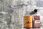 Distressed grey and white abstract area rug with weathered texture pattern
