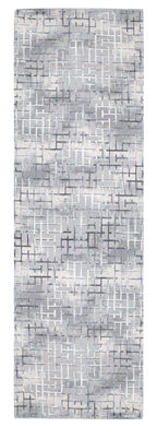 Modern geometric patterned rug in grey, white and blue tones with abstract design