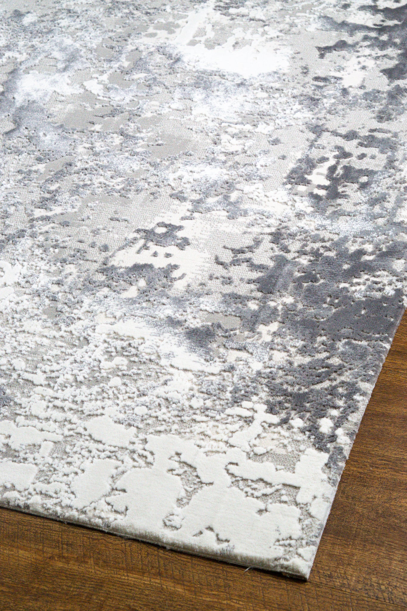 Modern abstract grey and white distressed texture area rug with mottled pattern