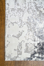 Modern abstract grey and white distressed texture area rug with mottled pattern
