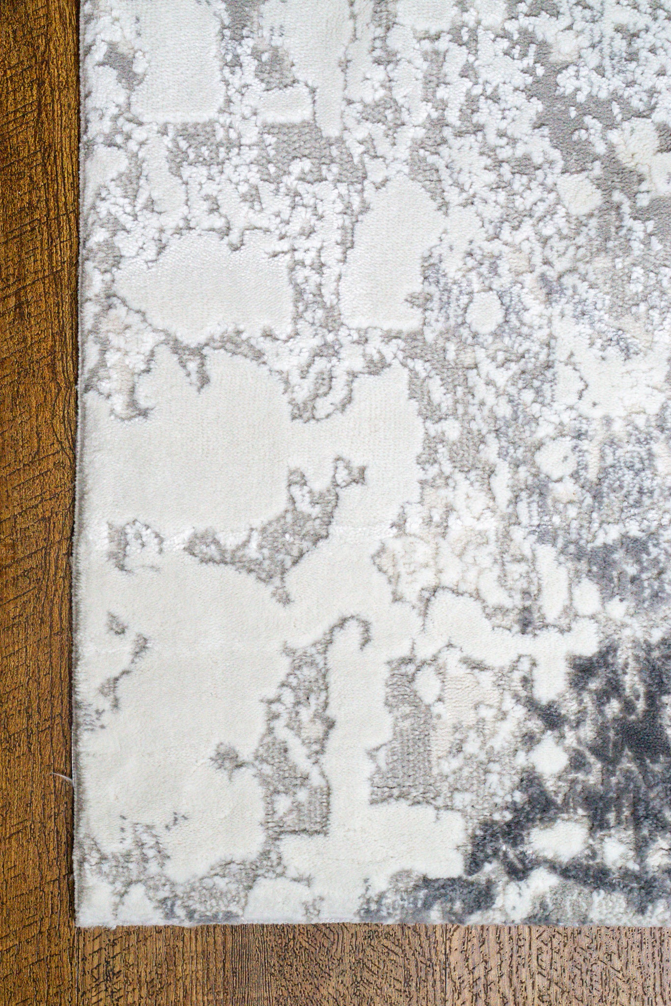 Modern abstract grey and white distressed texture area rug with mottled pattern