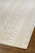 Geometric patterned rug in beige and cream with tribal diamond motifs