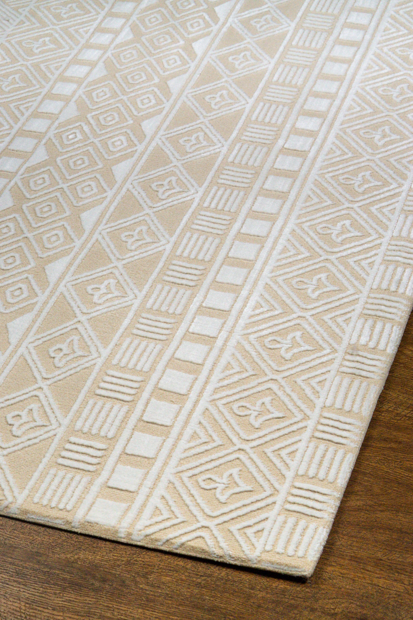 Geometric patterned rug in beige and cream with tribal diamond motifs