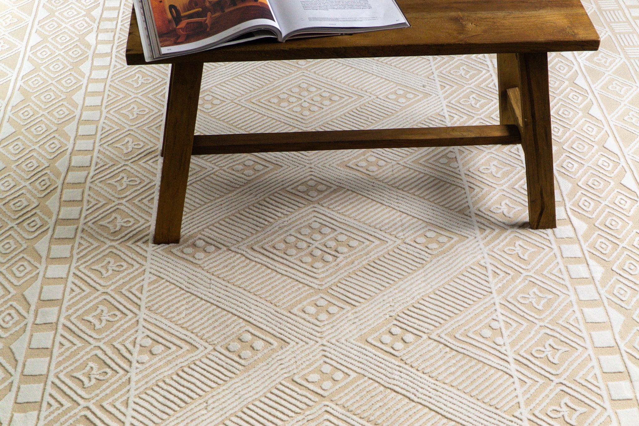 Geometric patterned rug in beige and cream with tribal diamond motifs