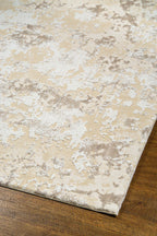 Distressed beige and cream textured rug with mottled vintage pattern