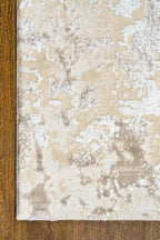 Distressed beige and cream textured rug with mottled vintage pattern