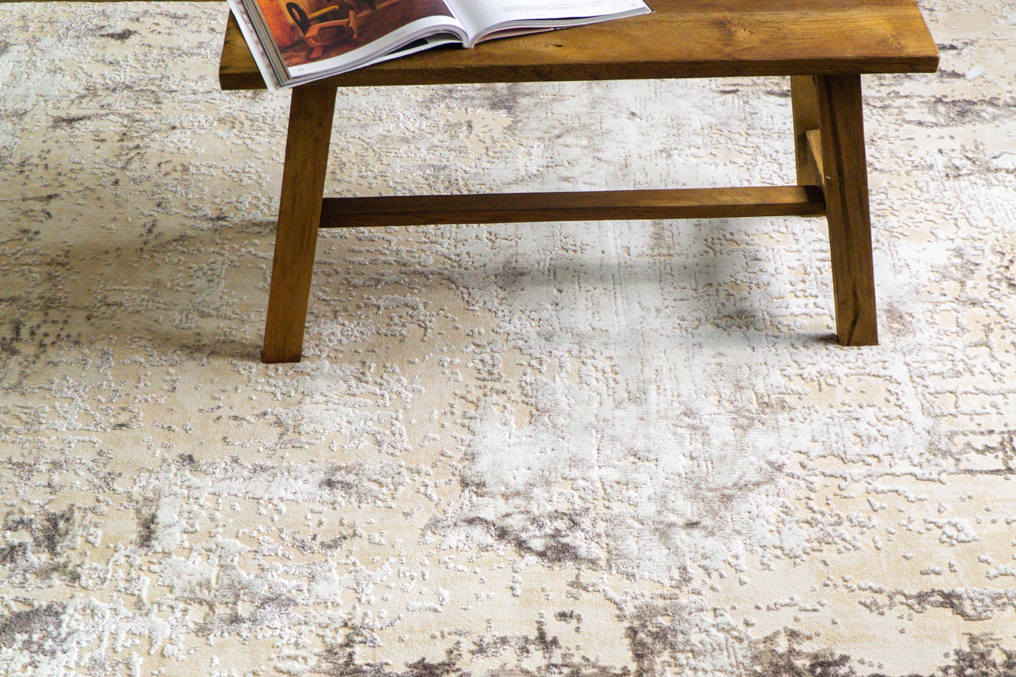 Distressed beige and gray textured rug with mottled vintage pattern