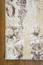 Distressed beige and gray textured rug with mottled vintage pattern