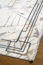 Cream and taupe abstract geometric rug with linear patterns and distressed finish