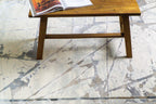 Cream and taupe abstract geometric rug with linear patterns and distressed finish
