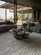 Modern geometric rug with nested square pattern in grey and cream tones