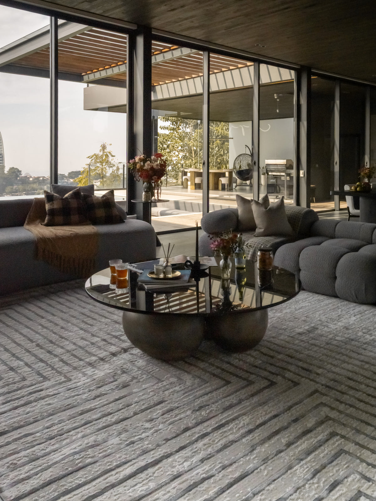 Modern geometric rug with nested square pattern in grey and cream tones