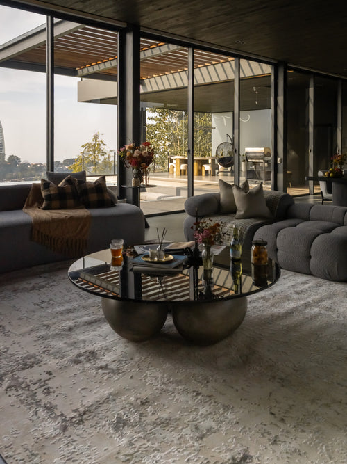 Distressed beige and gray textured rug with mottled vintage pattern