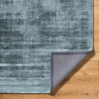Modern distressed blue-grey rug with abstract worn texture pattern