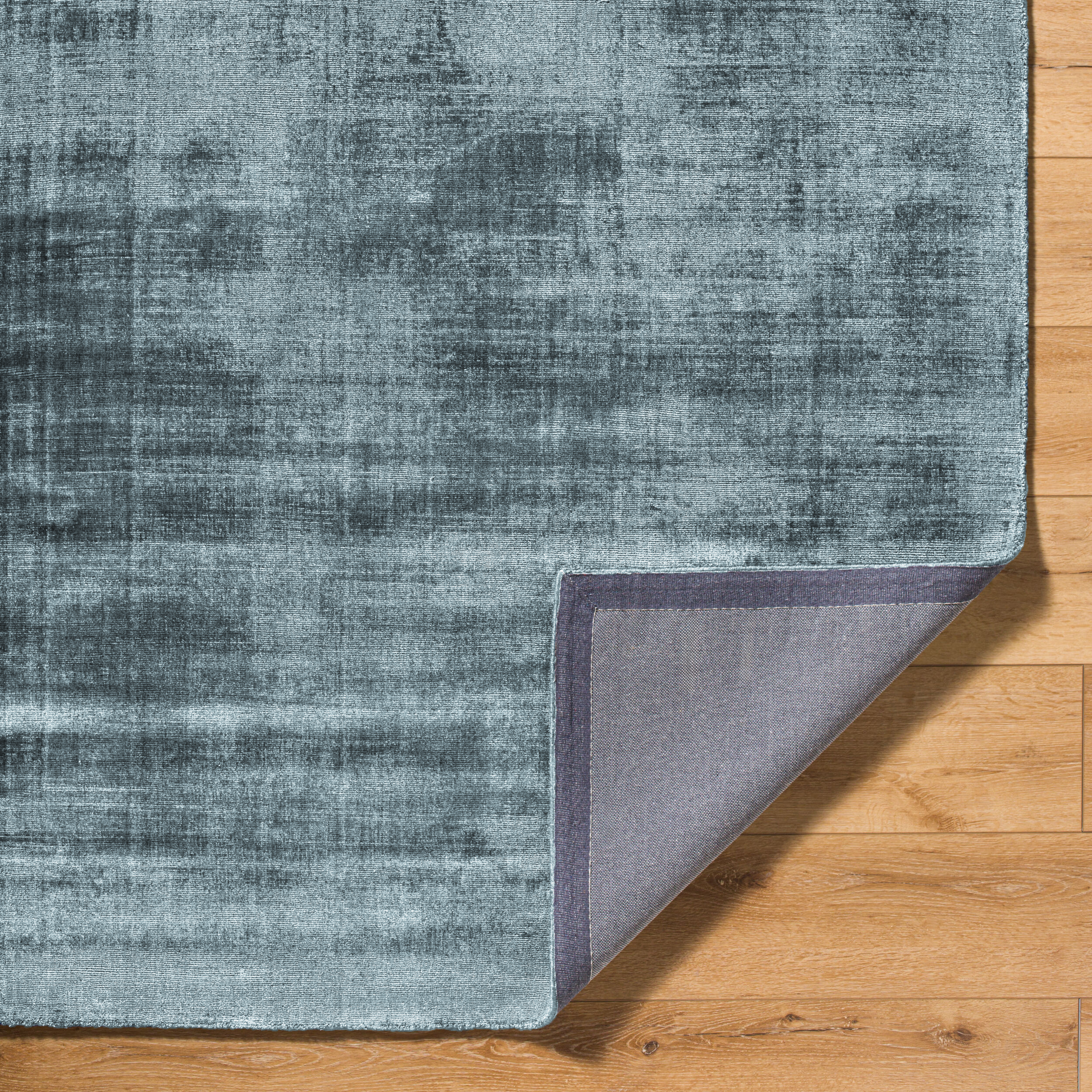 Modern distressed blue-grey rug with abstract worn texture pattern