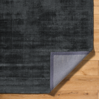 Dark grey distressed wool rug with subtle texture and mottled finish