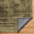 Distressed gold and charcoal textured area rug with abstract worn finish